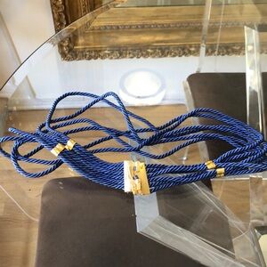 Blue belt made from rope with gold buckle